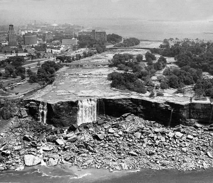 Aerial view of a historical cityscape with a near-dry waterfall, showcasing past urban development.