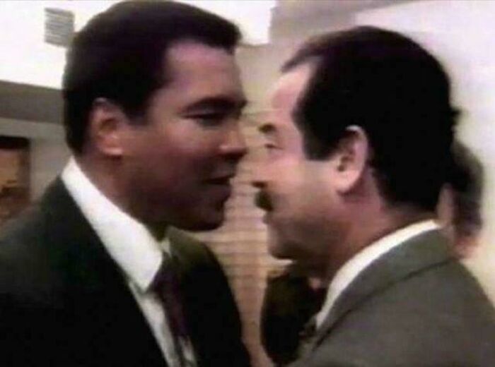 Two men in suits greet each other closely, creating a historical moment captured in the past.