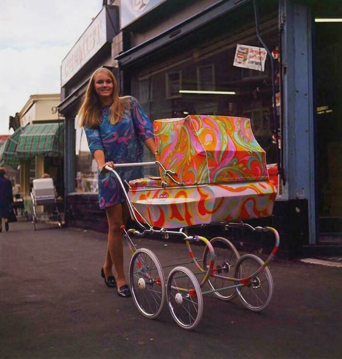 Woman with a vibrant, psychedelic stroller in a vintage street scene, representing historical changes in style.