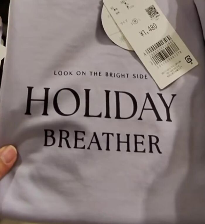 Purple shirt with "Look on the bright side, Holiday Breather" text, showcasing a unique translation in Japan.