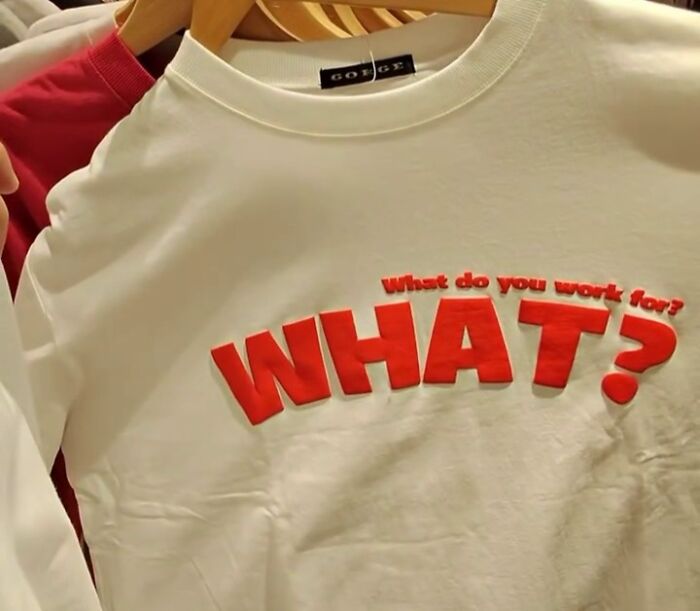 White T-shirt with red text, "What do you work for? WHAT?" featuring humorous translation.