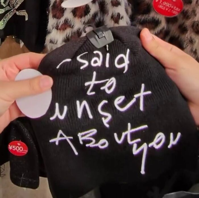 Poorly translated hat in Japan featuring abstract text design, highlighting choosy people and unique fashion.