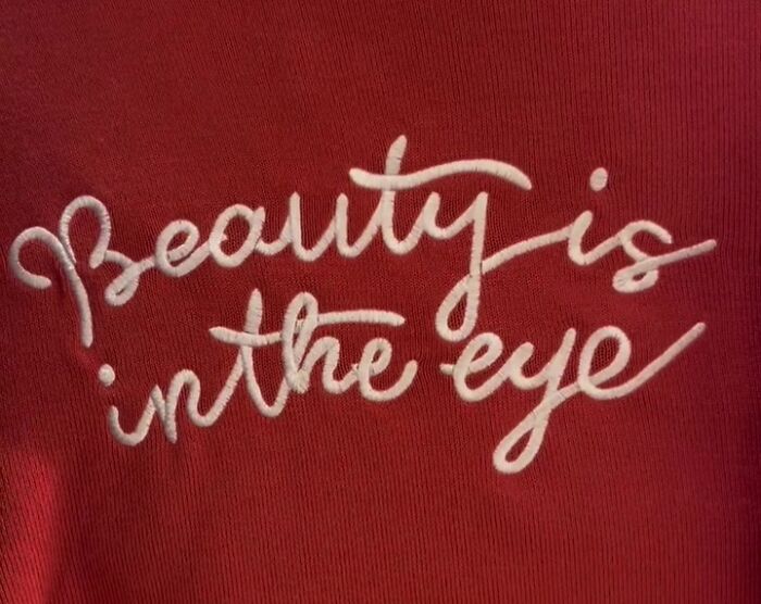Red shirt with the phrase "Beauty is in the eye" showcasing a humorous translation found in Japan.