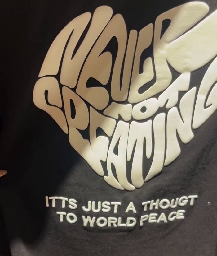 Poorly translated shirt in Japan featuring abstract text promoting world peace.