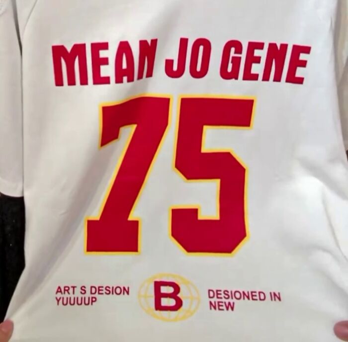 Poorly translated white shirt with "MEAN JO GENE 75" in red text.
