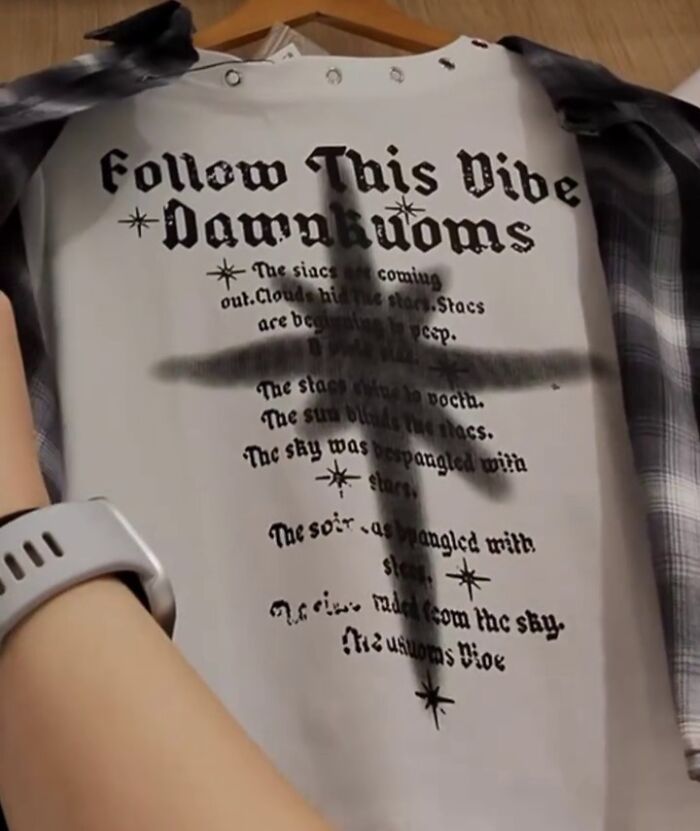 A poorly translated shirt in Japan reads "Follow This Vibe Damnkuoms" with text around a cross design.