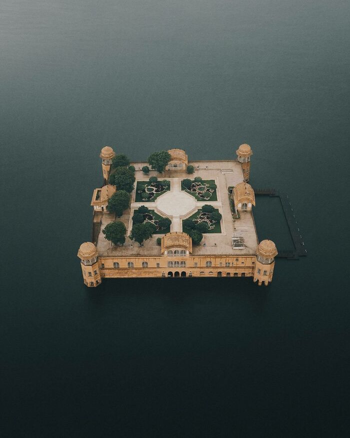 Aerial photo of an island palace surrounded by water, showcasing unique world perspectives from above.