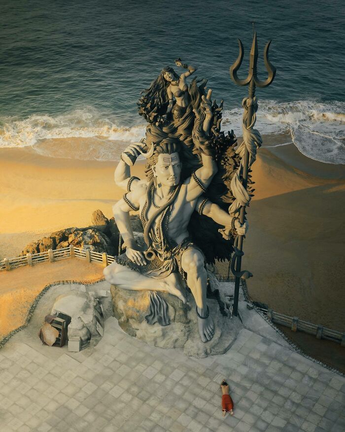 Aerial photo of a colossal statue by the sea, showcasing the world from a different angle.