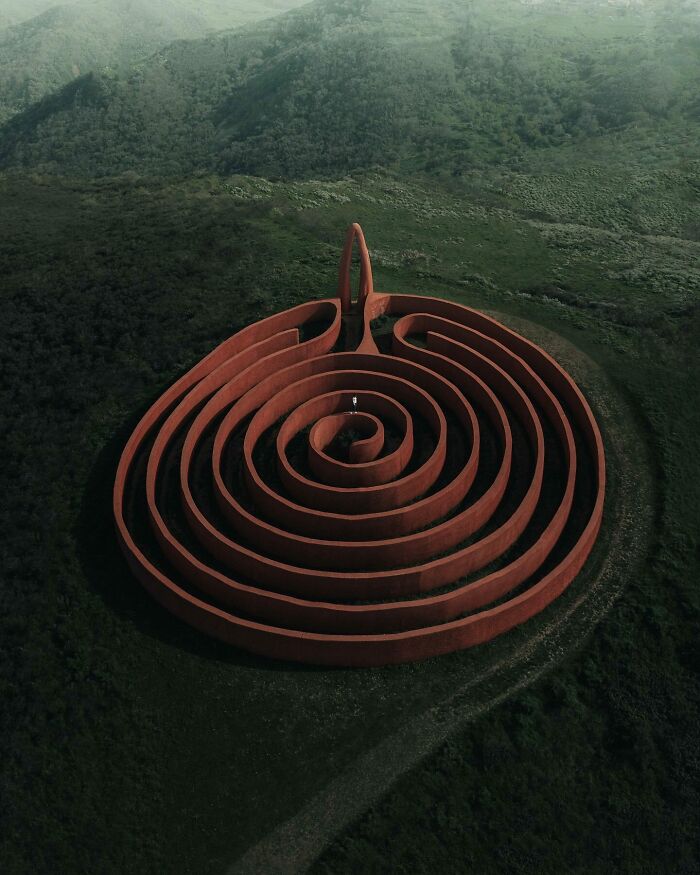 Aerial view of a spiral maze in lush green landscape, showcasing unique photography perspectives.