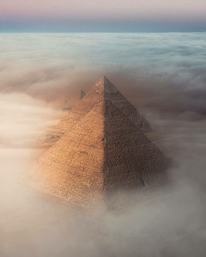 Aerial photo of the Pyramids shrouded in mist, showcasing the world from a different angle.