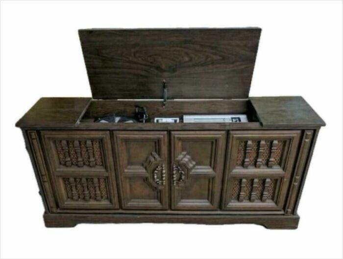 Vintage wooden stereo console with open lid, evoking nostalgia and a sense of feeling old.