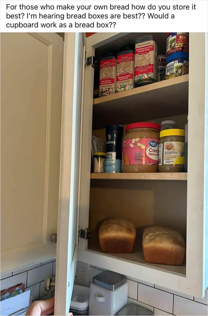 Cupboard with homemade bread and assorted pantry items, questioning if it serves as a bread box alternative.