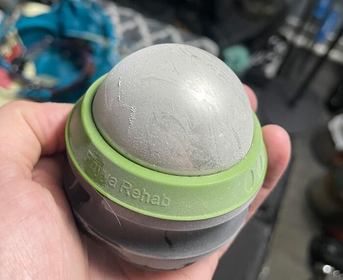 Hand holding a massage ball, unique gift idea instead of a typical mug.