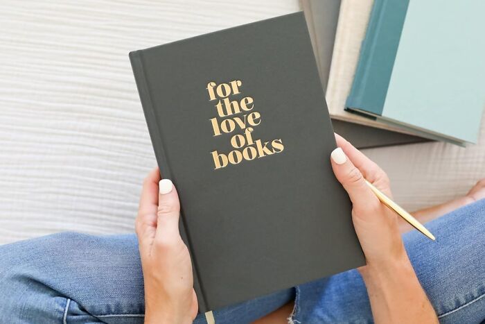 Person holding a book titled "For the Love of Books," perfect gift idea beyond mugs.