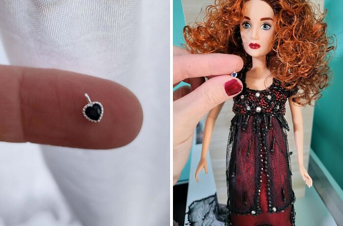Tiny black heart-shaped earring found in the ocean, held next to a doll in a black and red dress.