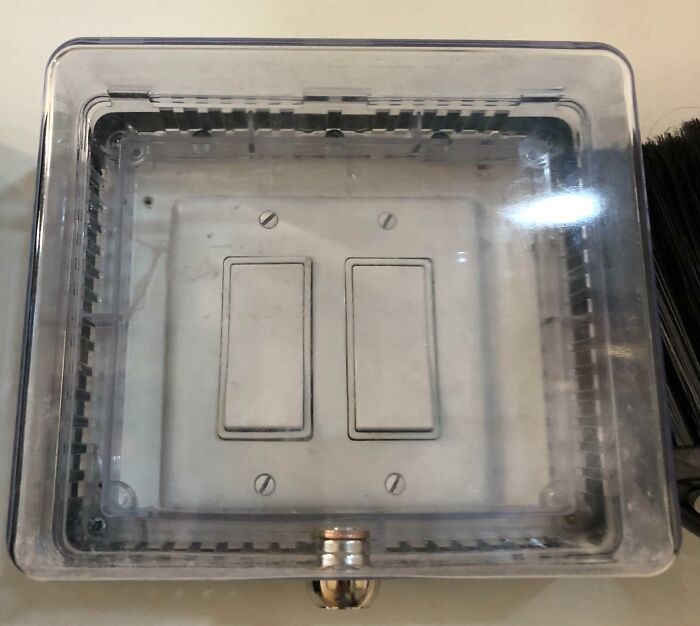 Light switches enclosed in a transparent lockbox, symbolizing managerial control for infuriating bosses.
