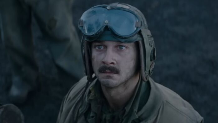 Actor in military costume wearing helmet and goggles, showcasing dedication actors go above and beyond for difficult roles
