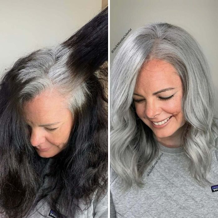 Woman showcasing transformation to natural gray hair, smiling in a gray shirt, highlights embracing her new look.