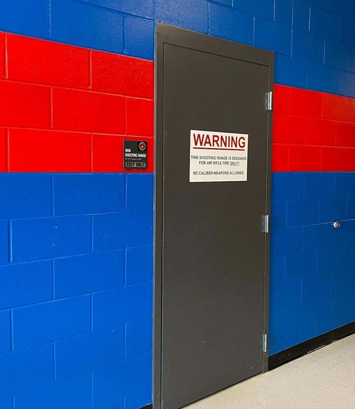 School hallway with a warning sign on a door to the shooting range, highlighting unique aspects of American schools.