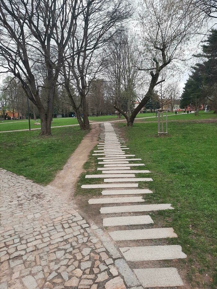 Path in a park with misaligned stepping stones showing city planners' oversight.