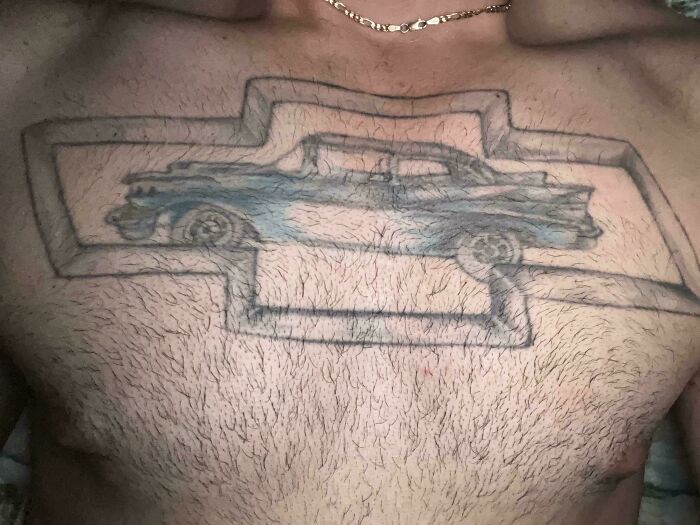 Chest tattoo featuring a poorly drawn classic car inside an uneven Chevrolet logo, showcasing a wild tattoo fail on hairy skin.