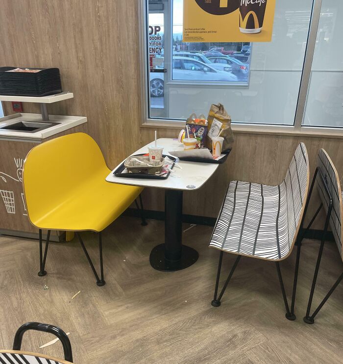 Fast food table with leftover trash and packaging, demonstrating lack of basic etiquette.