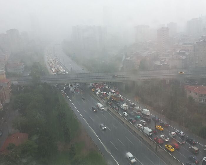 Traffic jam in rainy weather on a city highway, highlighting a moment of lacking basic etiquette on the road.
