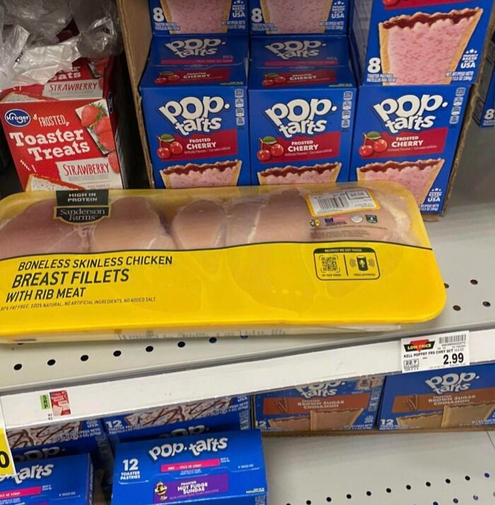 Chicken fillets misplaced on Pop-Tarts shelf, lacking basic etiquette in grocery store display.