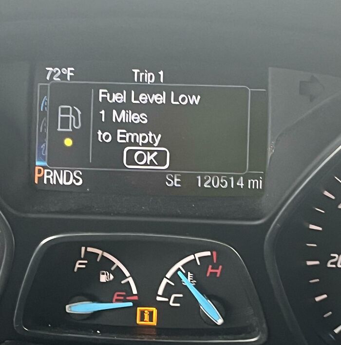 Car dashboard warning of low fuel, miles away from empty, highlighting a lapse in basic etiquette.