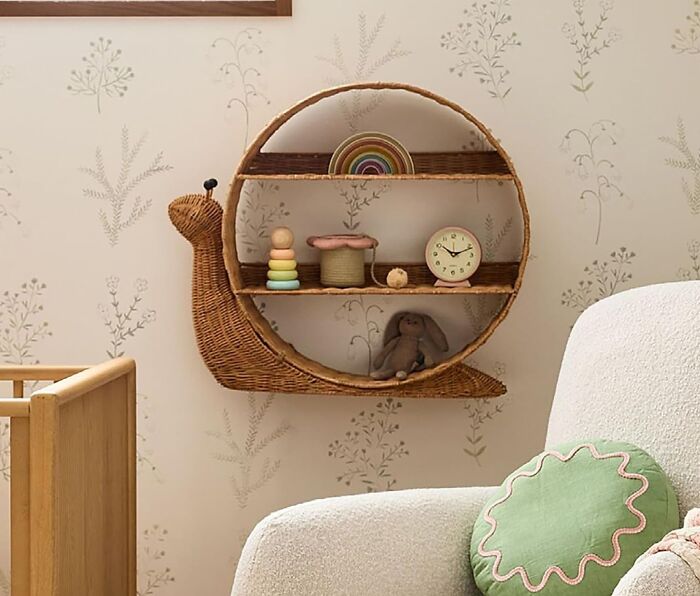 Stylish wicker snail shelf with decor accessories, enhancing a generic apartment's cozy vibe.