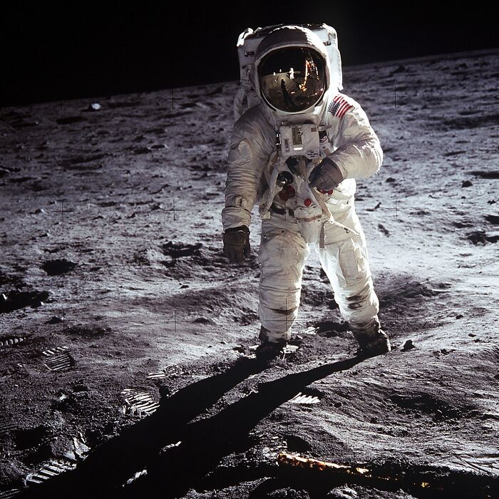 Astronaut walking on the moon's surface, showcasing historical coincidences in space exploration.