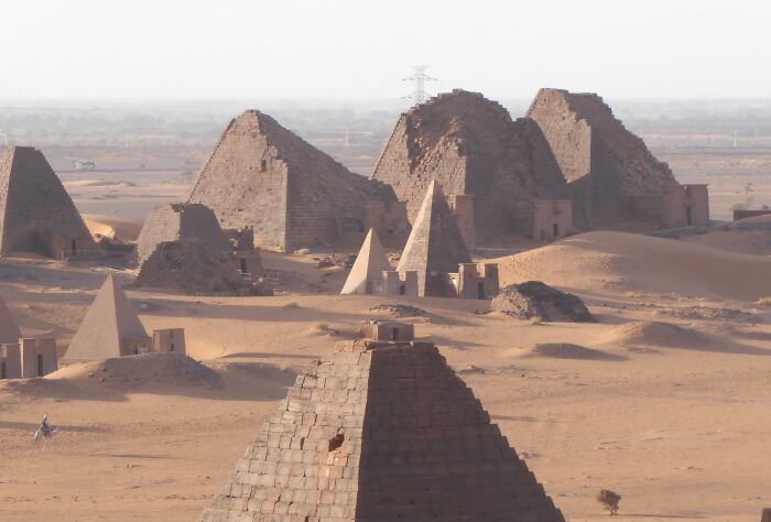 Ancient lesser-known pyramids standing in a desert landscape, showcasing architectural wonders from history.