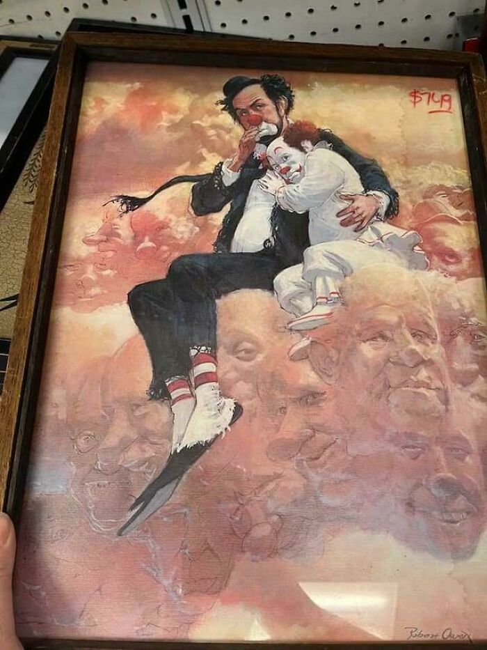 Unusual painting found at Goodwill featuring two clowns sitting among clouds with faces, priced at $7.49.