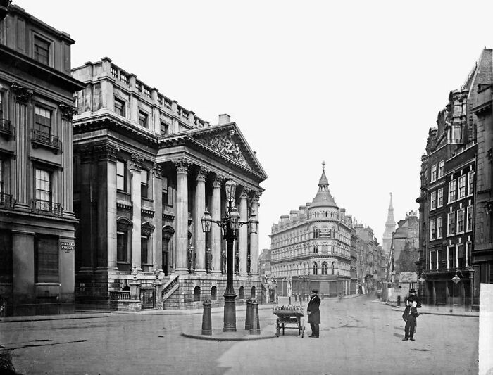 Historic black and white photo showing life in Europe 100 years ago with classic architecture and street scene.
