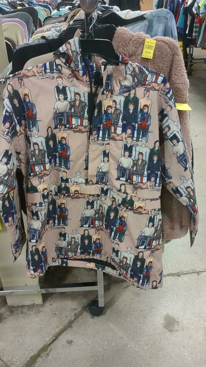 Goodwill hidden gem: a unique jacket with an unusual print featuring various figures on display in the store.