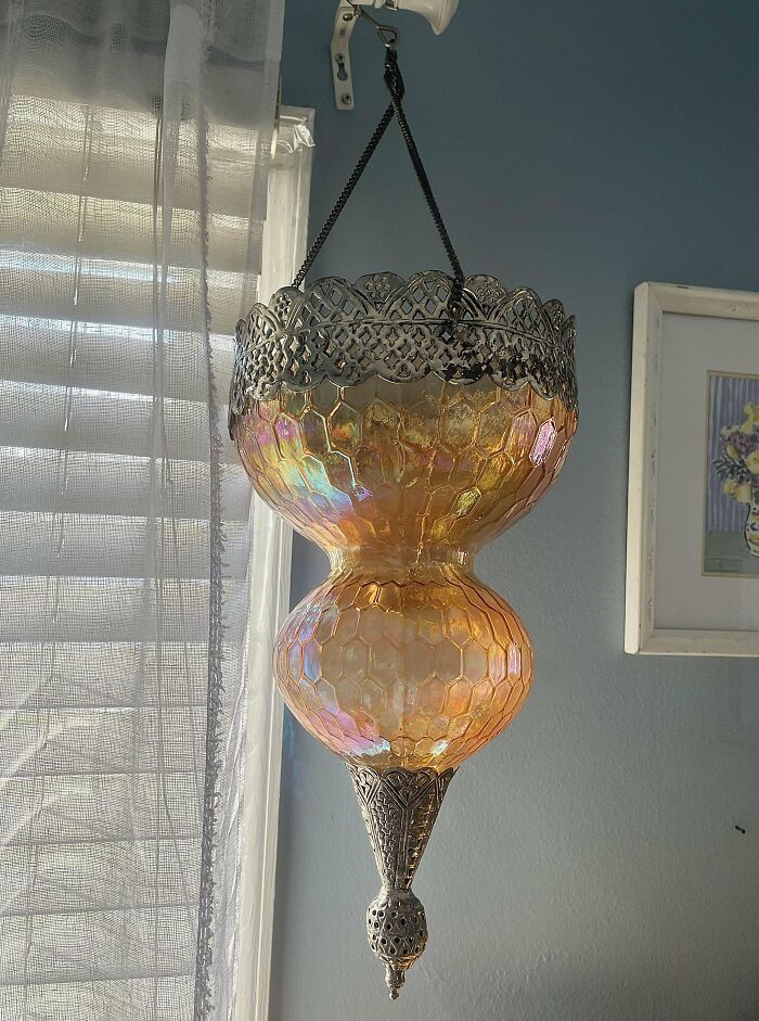 Ornate, iridescent lantern found at Goodwill, showcasing unique design and colorful reflections in a living room.