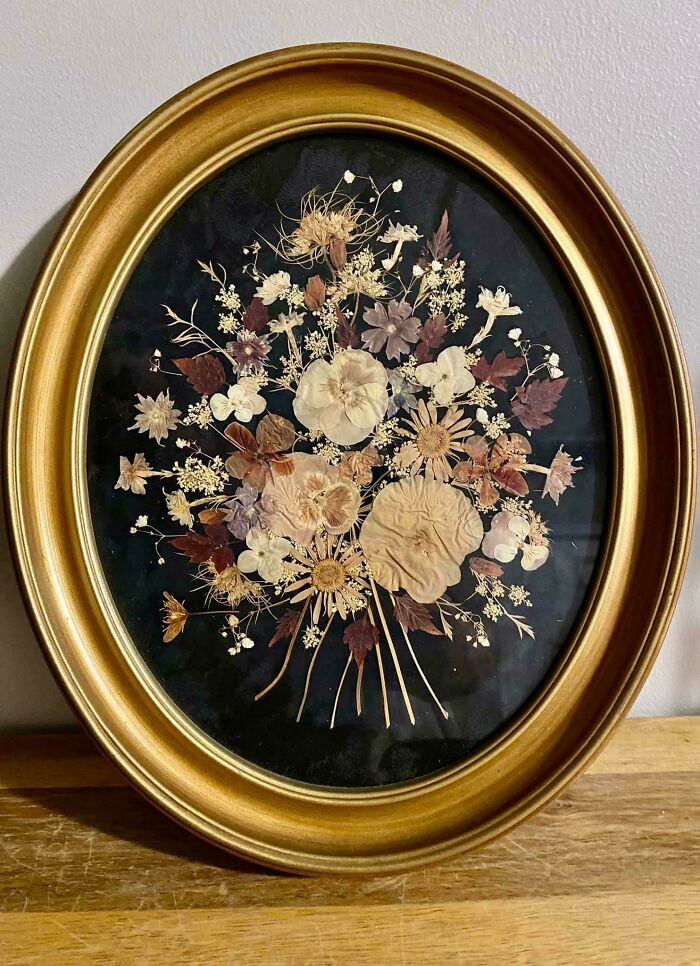Ornate gold-framed floral artwork, a hidden gem discovered at Goodwill.