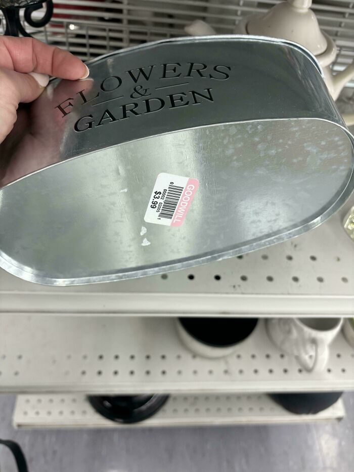 Goodwill find: metal "Flowers & Garden" container with price tag visible.
