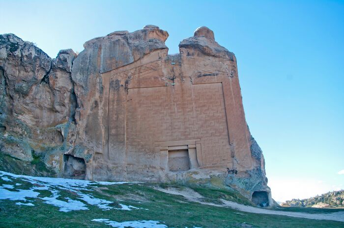 Ancient architectural wonder carved into a large rock formation, featuring intricate geometric patterns.