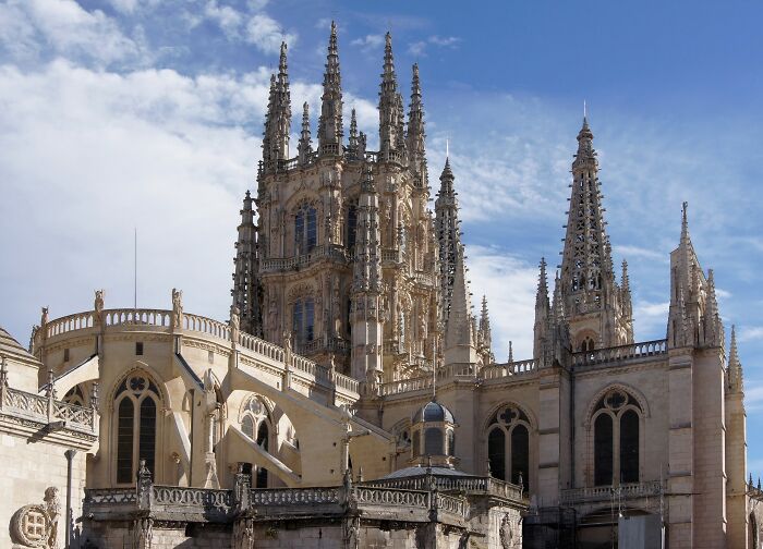 Gothic architectural wonder with intricate spires and detailed stonework under a blue sky.