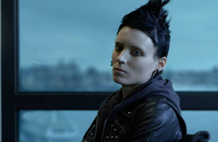 Actor in punk style with spiked hair and leather jacket, showcasing dedication to difficult roles and acting challenges.