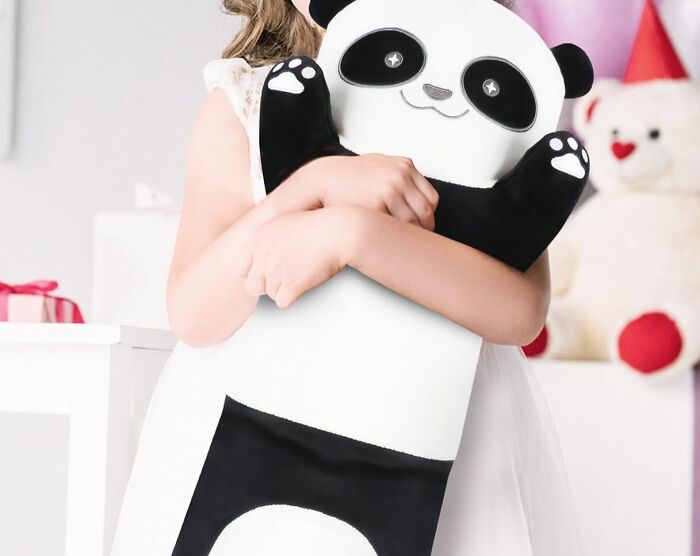 Child hugging a large panda plushie in a bright room, featuring the Bored Panda children's book theme.