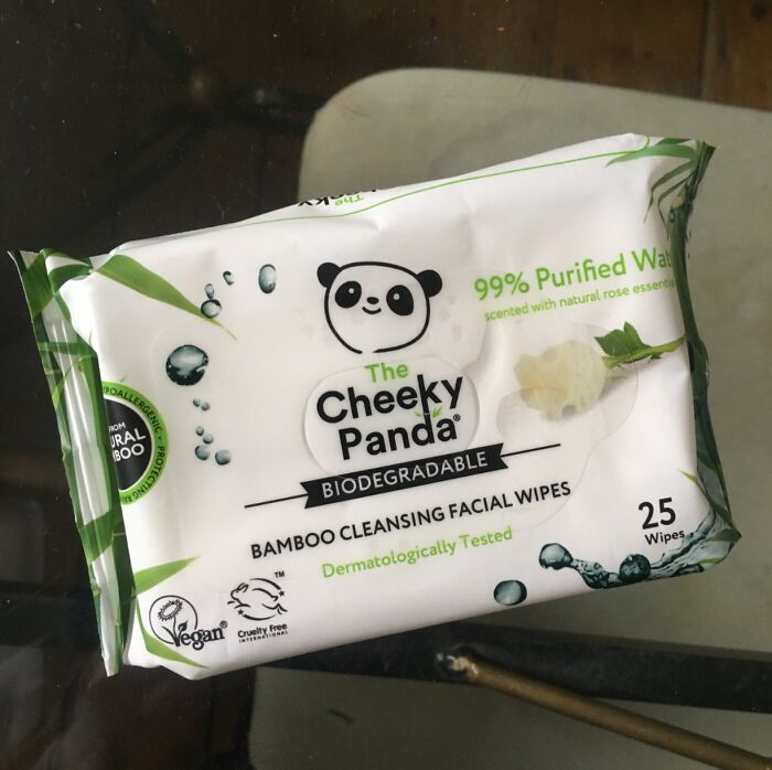 Package of Cheeky Panda bamboo facial wipes on a glass table.