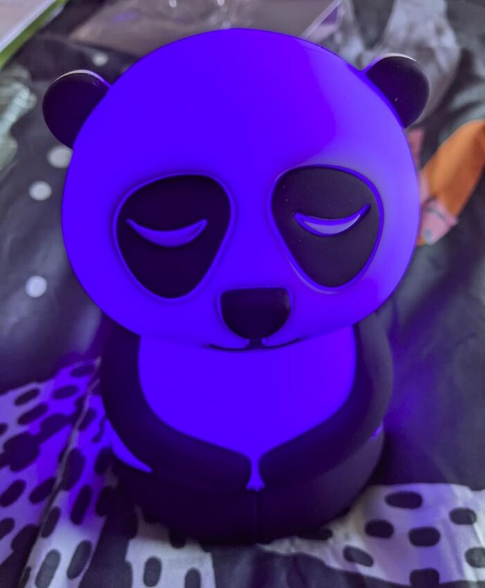 Cute panda nightlight from Bored Panda children's book on a patterned surface.