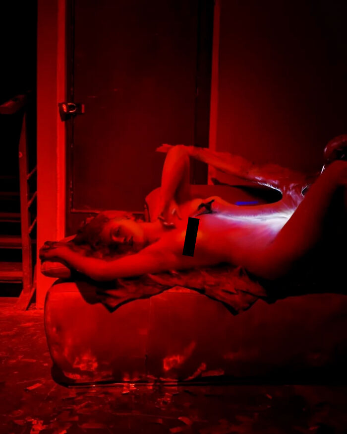 Classical figure artfully integrated into a modern red-lit setting by Alexey Kondakov.