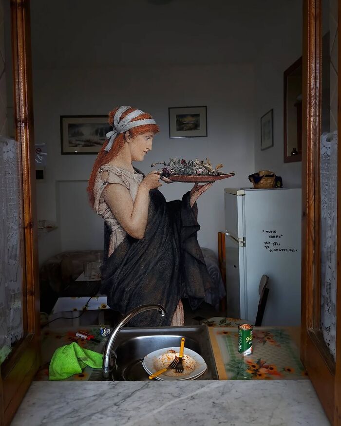 Classical figure by Alexey Kondakov holding a platter in a modern kitchen environment.