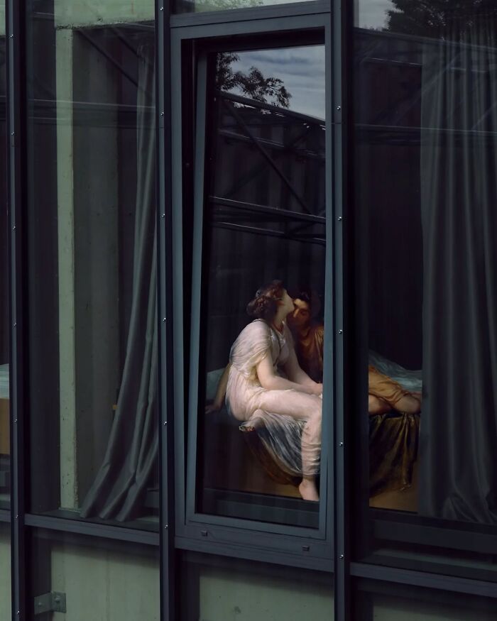 Classical figures kissing viewed through modern glass window, blending art eras creatively.
