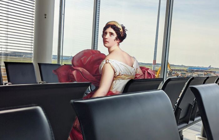 Classical figure sitting in a modern airport terminal with empty black chairs and a large window view of the runway.