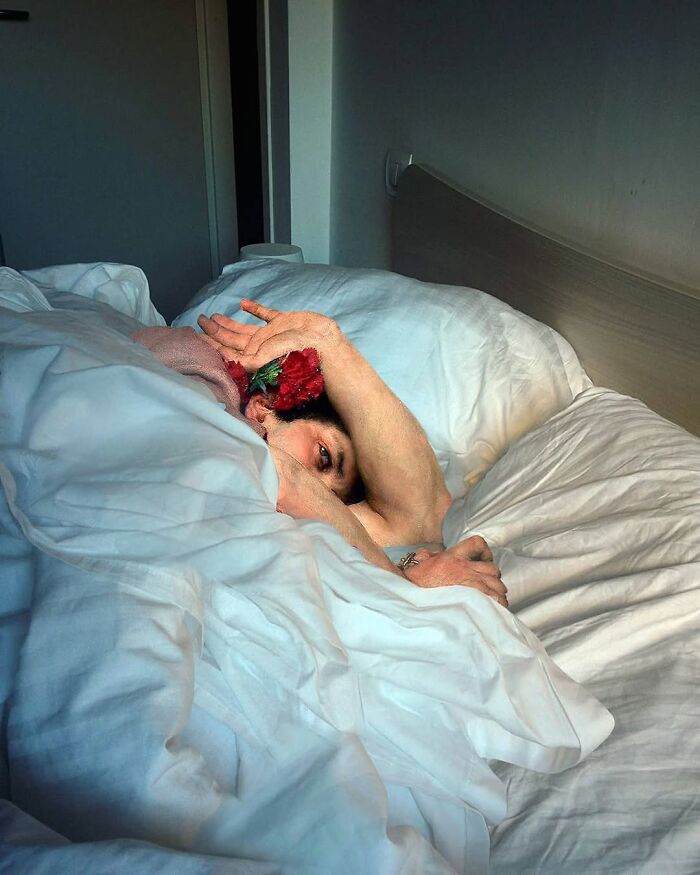 Classical figure in a modern bedroom, blending old art with contemporary surroundings.