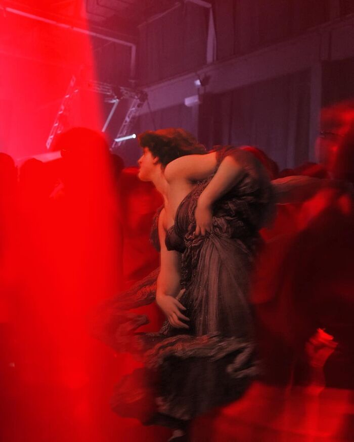 Classical figure in a modern, vibrant red environment, blending time periods with dramatic lighting.